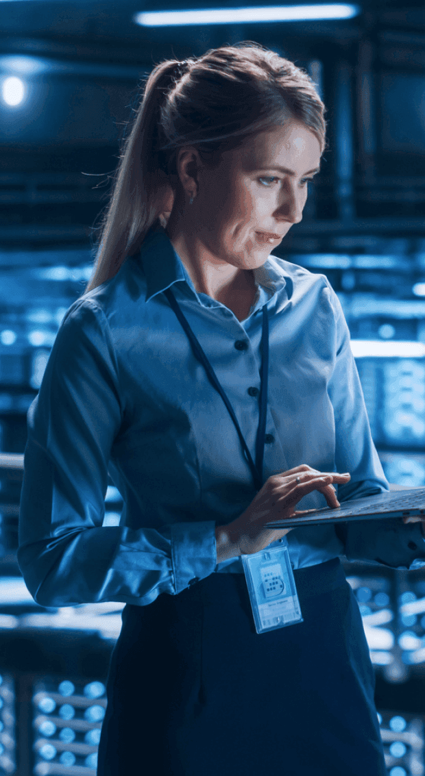 Women working on laptop in factory.